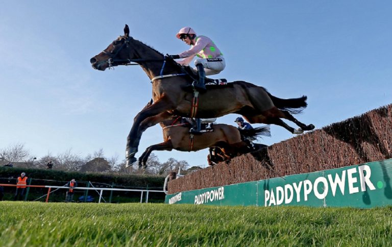 Min ridden by Ruby Walsh clears the first on the way to winning The Racing Post Novice Steeplechase 26/12/2016