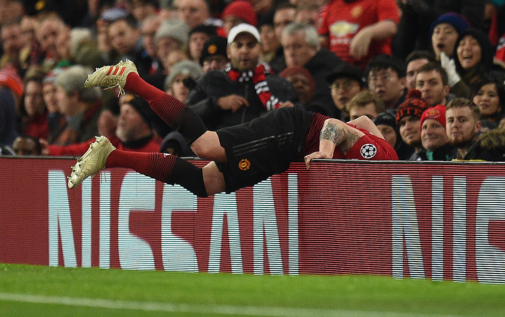 Phil-Jones-CL-falling-over-hoarding