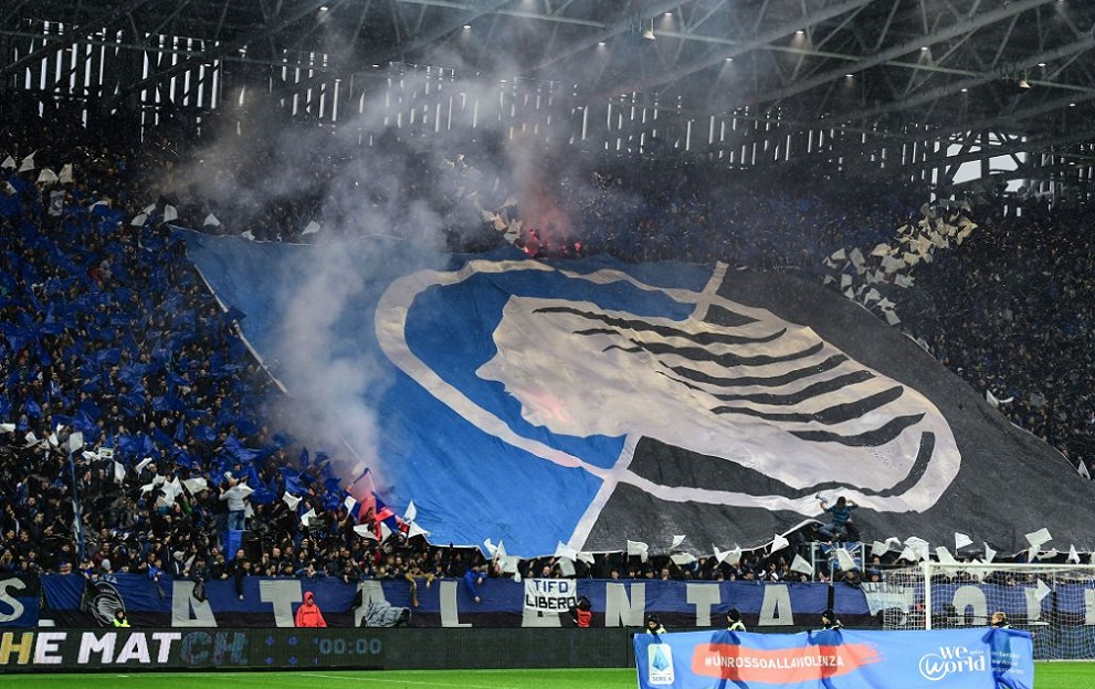 Fans unfurl a huge tifo as children hold a banner reading 