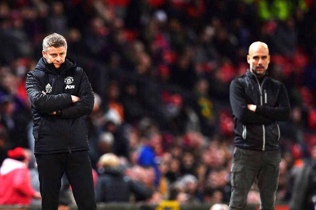 TOPSHOT - Manchester United's Norwegian manager Ole Gunnar Solskjaer (L) and Manchester City's Spanish manager Pep Guardiola react during the English League Cup semi-final first leg football match between Manchester United and Manchester City at Old Trafford in Manchester, north west England on January 7, 2020. - Manchester City won the match 3-1. (Photo by Paul ELLIS / AFP) / RESTRICTED TO EDITORIAL USE. No use with unauthorized audio, video, data, fixture lists, club/league logos or 'live' services. Online in-match use limited to 75 images, no video emulation. No use in betting, games or single club/league/player publications. / (Photo by PAUL ELLIS/AFP via Getty Images)
