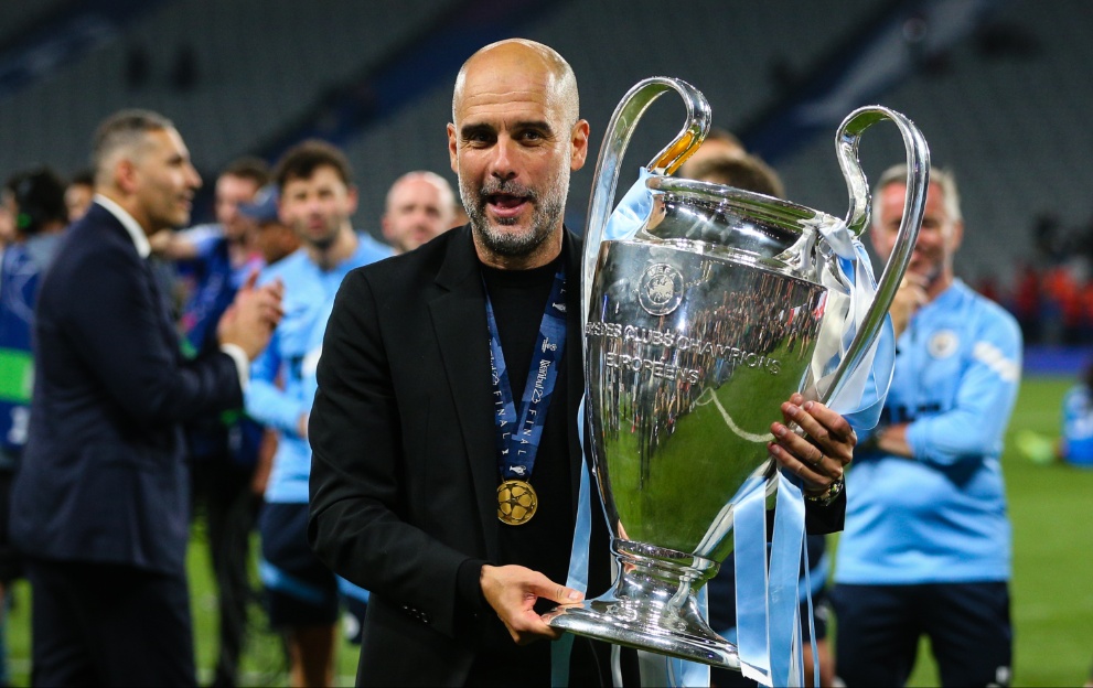 Pep Guardiola poses with the Champions League trophy