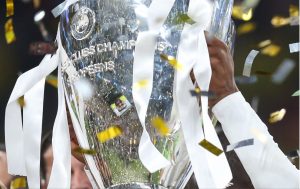 A player lifting the Champions League Trophy