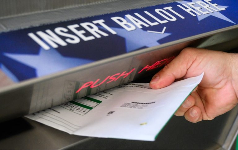 A voting slip being posted in a ballot box for the US Presidential Election