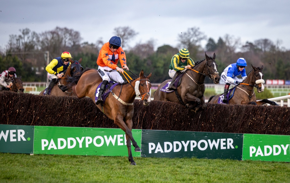 Horses jumping a fence in the Dublin Racing Festival at Leopardstown