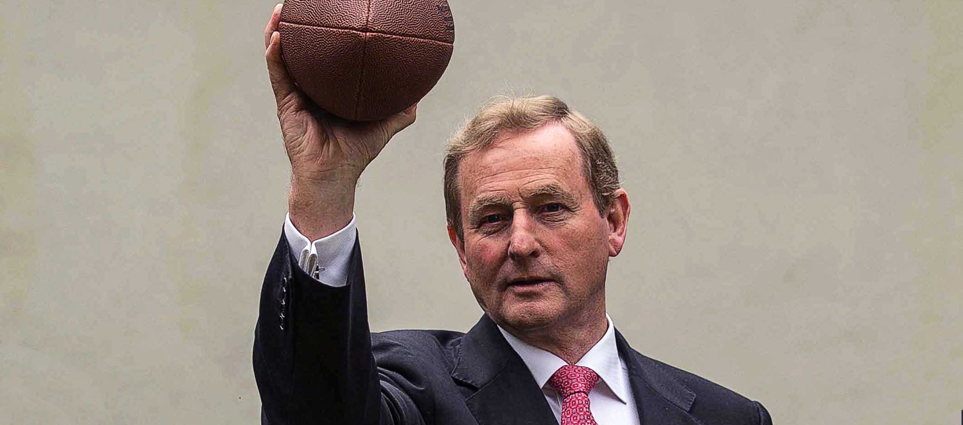 Enda Kenny pretending he knows how to hold an American football