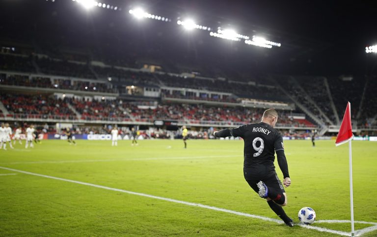D.C. United forward Wayne Rooney takes a corner kick