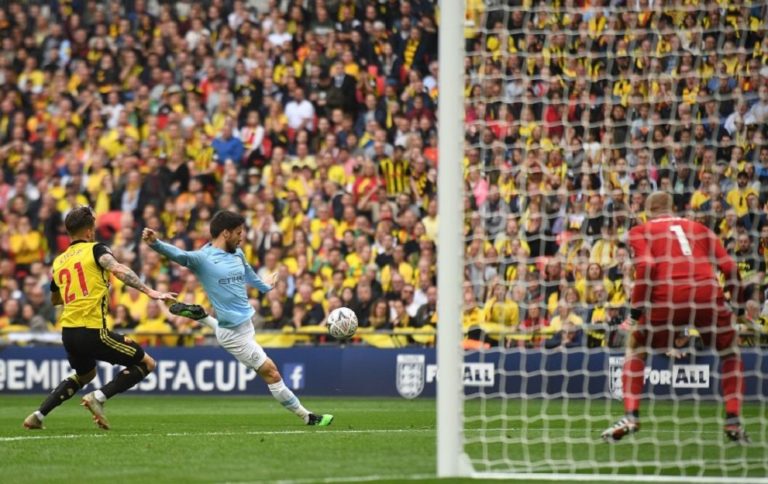 Manchester City's Spanish midfielder David Silva (C) scores the team's first goal during the English FA Cup final football match between Manchester City and Watford at Wembley Stadium in London, on May 18, 2019. (Photo by Daniel LEAL-OLIVAS / AFP) / NOT FOR MARKETING OR ADVERTISING USE / RESTRICTED TO EDITORIAL USE (Photo credit should read DANIEL LEAL-OLIVAS/AFP/Getty Images)