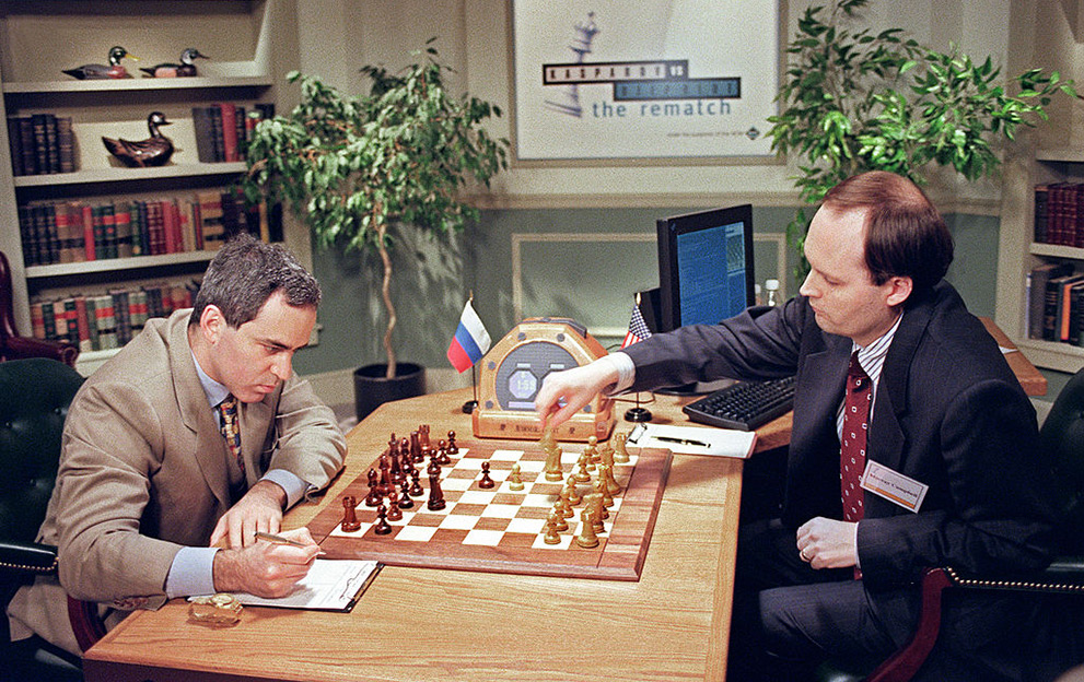 NEW YORK, UNITED STATES: IBM scientist Murray Campbell (R) makes a move for the IBM Deep Blue computer in game 04 May 1997 in New York against World Chess Champion Garry Kasparov (L). The monitor at rear on table relays the computers' moves to Campbell. Kasparov, making a record of the move, won the first game on 03 May and leads the match,1-0. AFP PHOTO/Stan HONDA (Photo credit should read STAN HONDA/AFP via Getty Images)