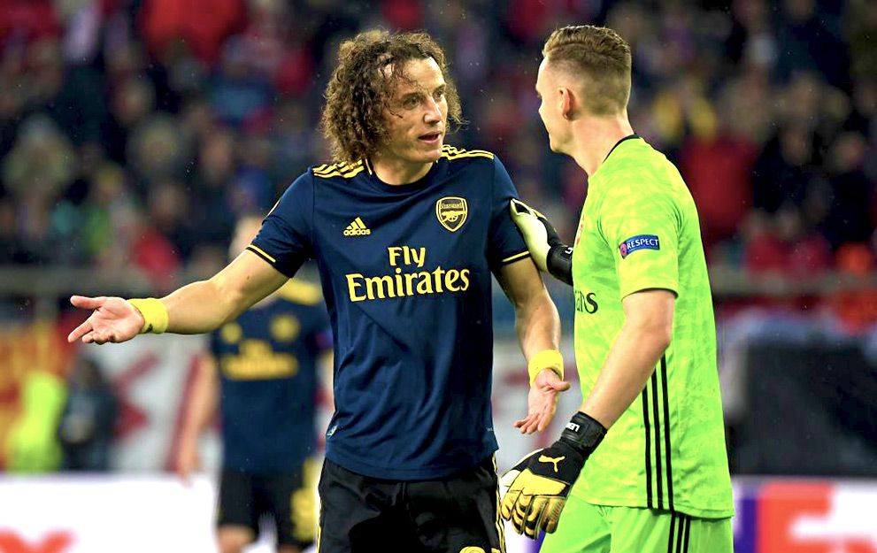 Arsenal's Brazilian defender David Luiz (L) and Arsenal's German goalkeeper Bernd Leno (R) have words during the UEFA Europa League round of 32 first leg football match between Olympiakos and Arsenal at the Karaiskakis Stadium in Piraeus, near Athens, on February 20, 2020. (Photo by ARIS MESSINIS / AFP) (Photo by ARIS MESSINIS/AFP via Getty Images)