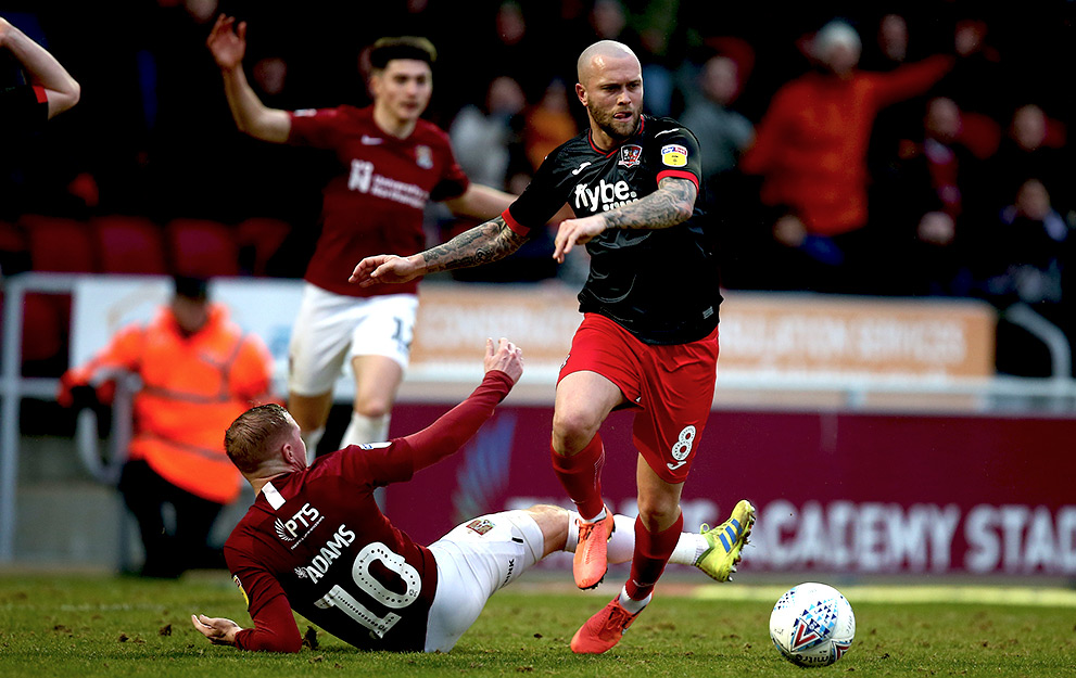 NORTHAMPTON, ENGLAND - FEBRUARY 22: Nicky Law of Exeter City moves forward with the ball during the Sky Bet League Two match between Northampton Town and Exeter City at PTS Academy Stadium on February 22, 2020 in Northampton, England. (Photo by Pete Norton/Getty Images)