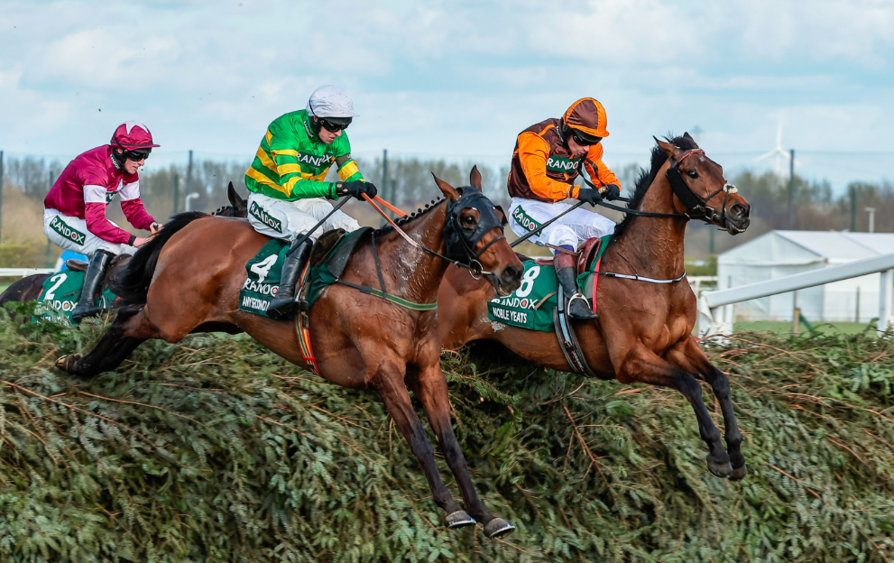 Horses jump the Grand National fences at Aintree